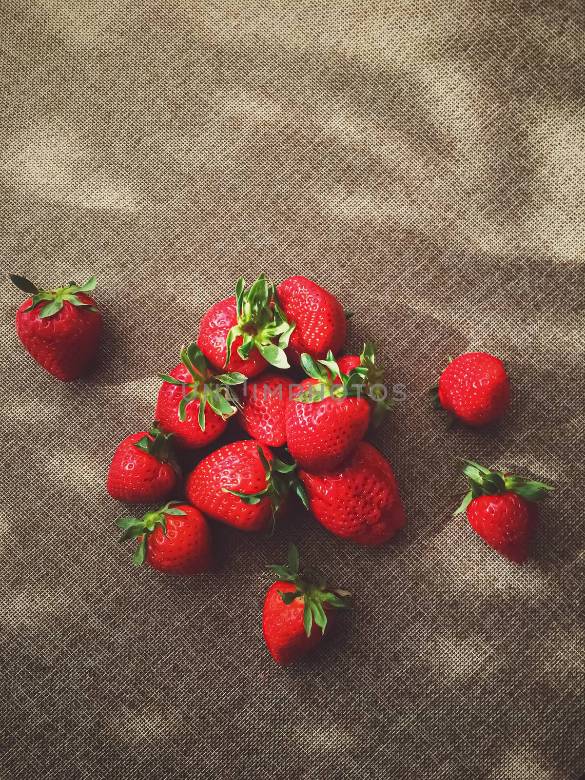 Organic strawberries on rustic linen background by Anneleven