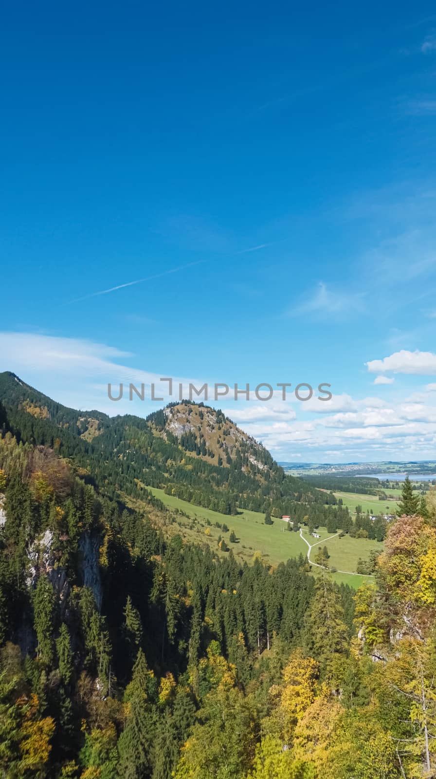 Beautiful nature of European Alps, landscape view of alpine mountains, lake and village on a sunny day, travel and destination scenery