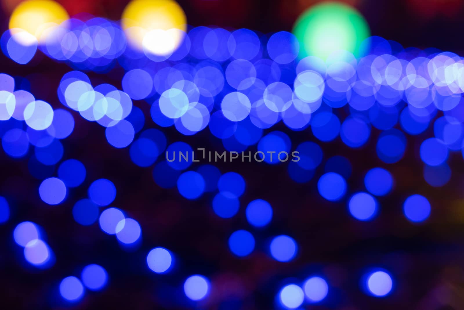 Defocused abstract blue christmas background with orange light