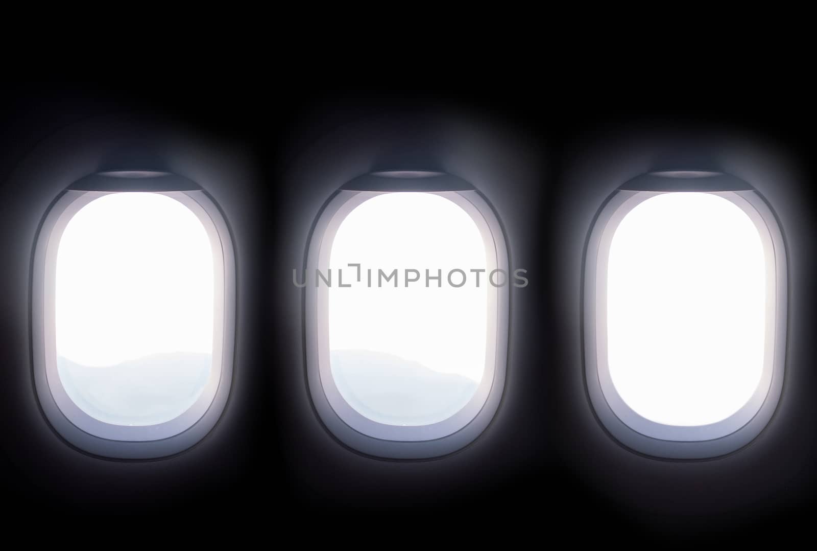 three airplane windows open white window shutter wide out to view of mountain hilltop during travel by air by asiandelight
