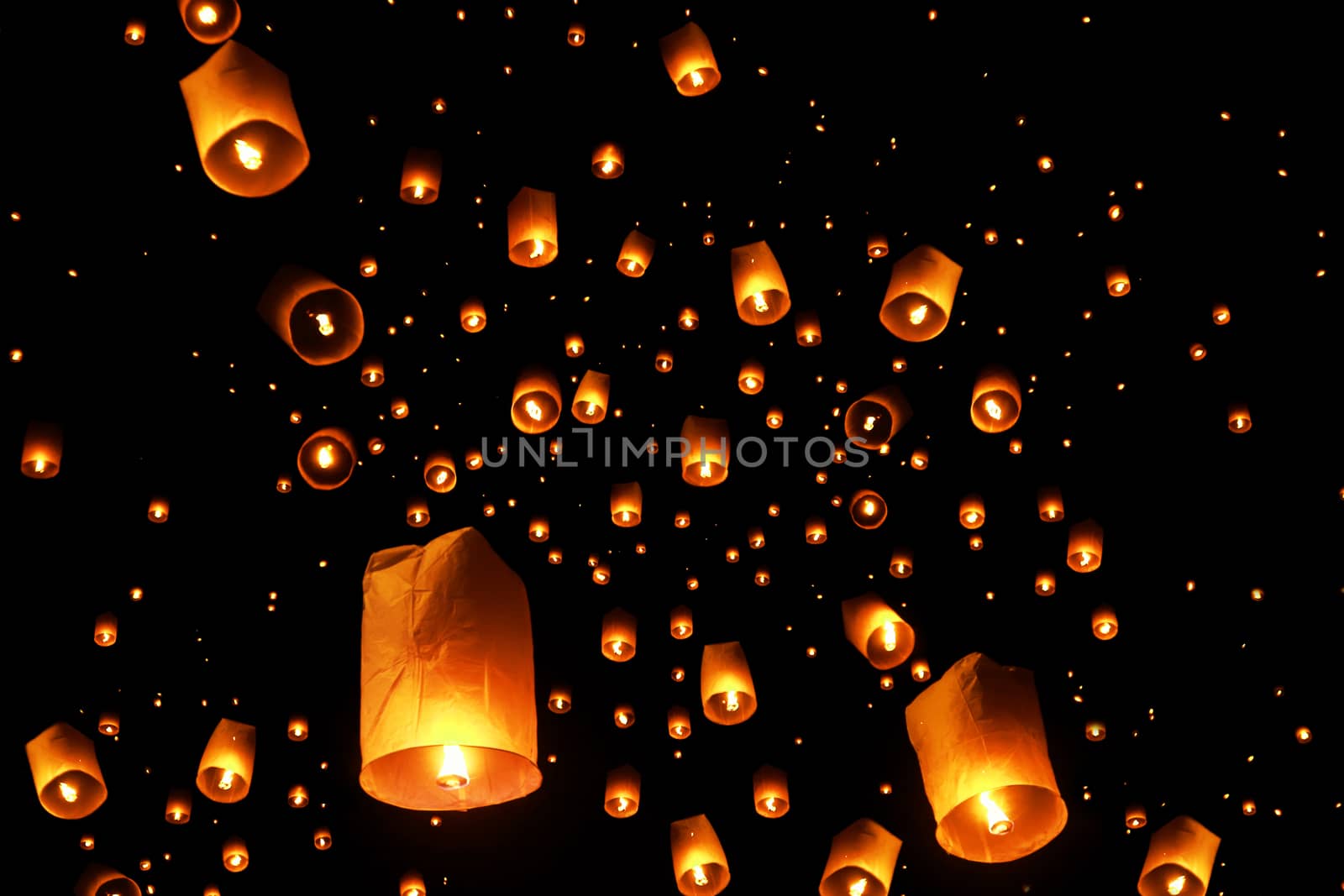 swarms of sky floating lanterns are launched into the air during New year's eve and Yee Peng lantern festival traditional at Chiang Mai , Thailand.