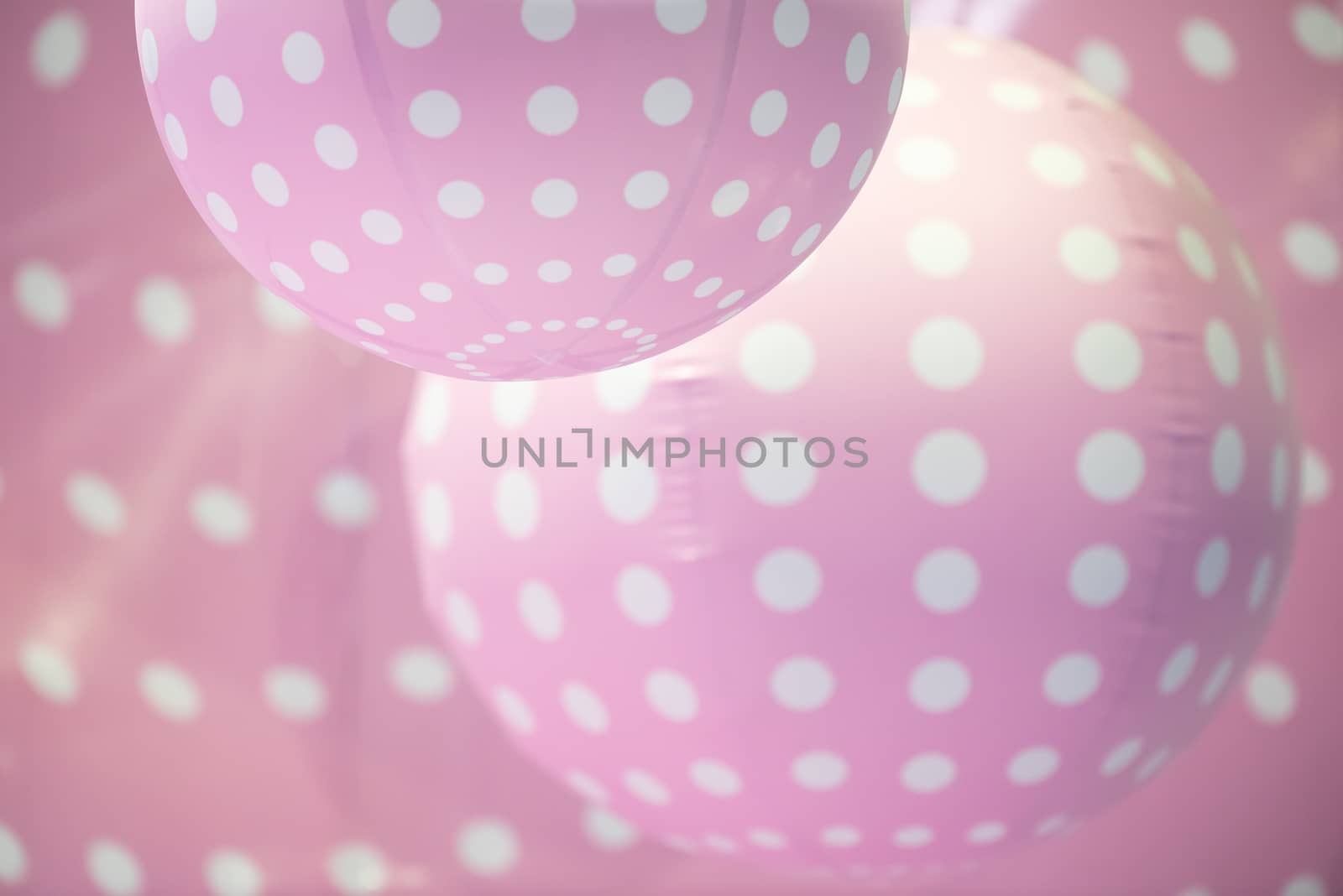 Pink plastic balls with white dots background