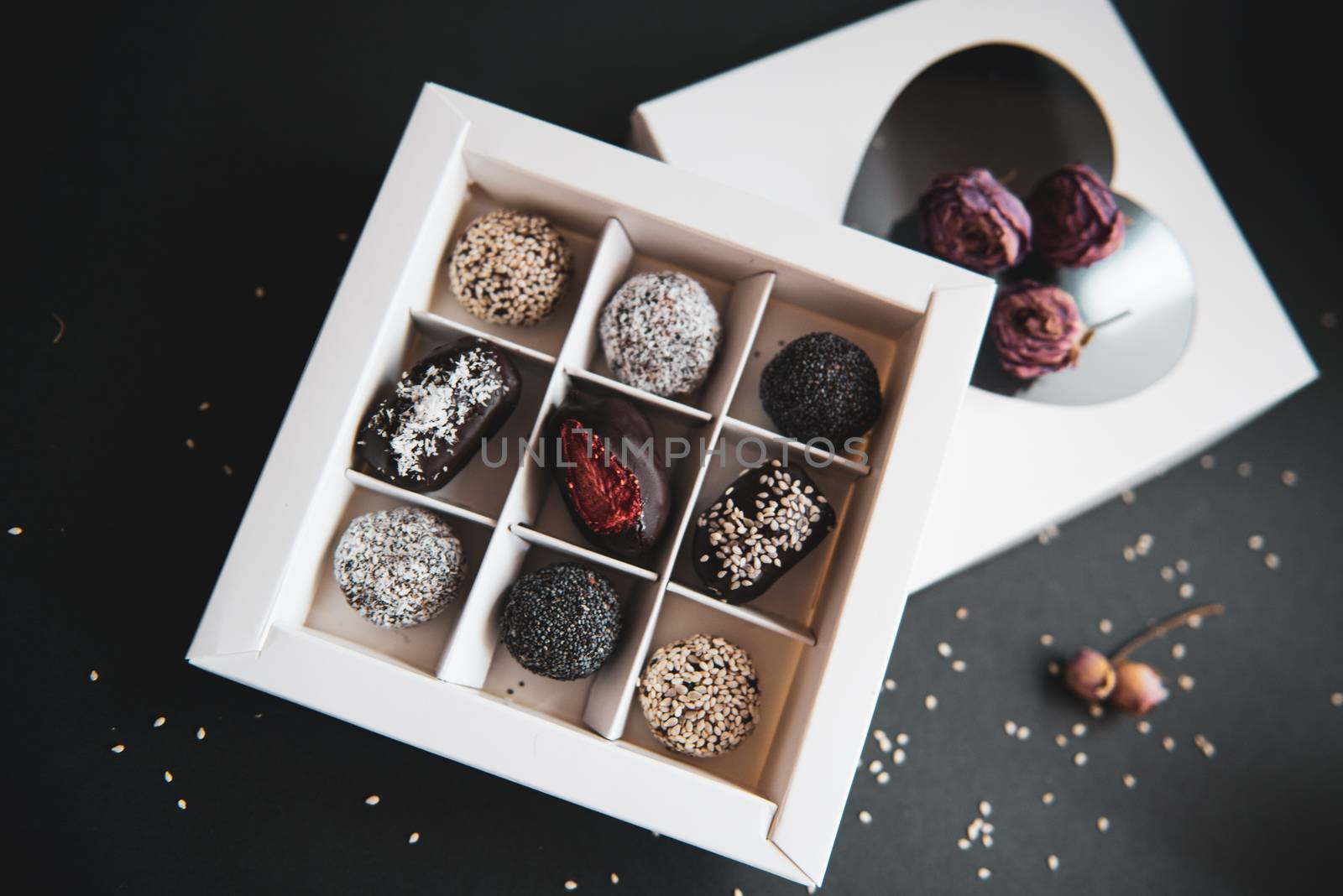 handmade fruit and chocolate candies in a white box by marynkin