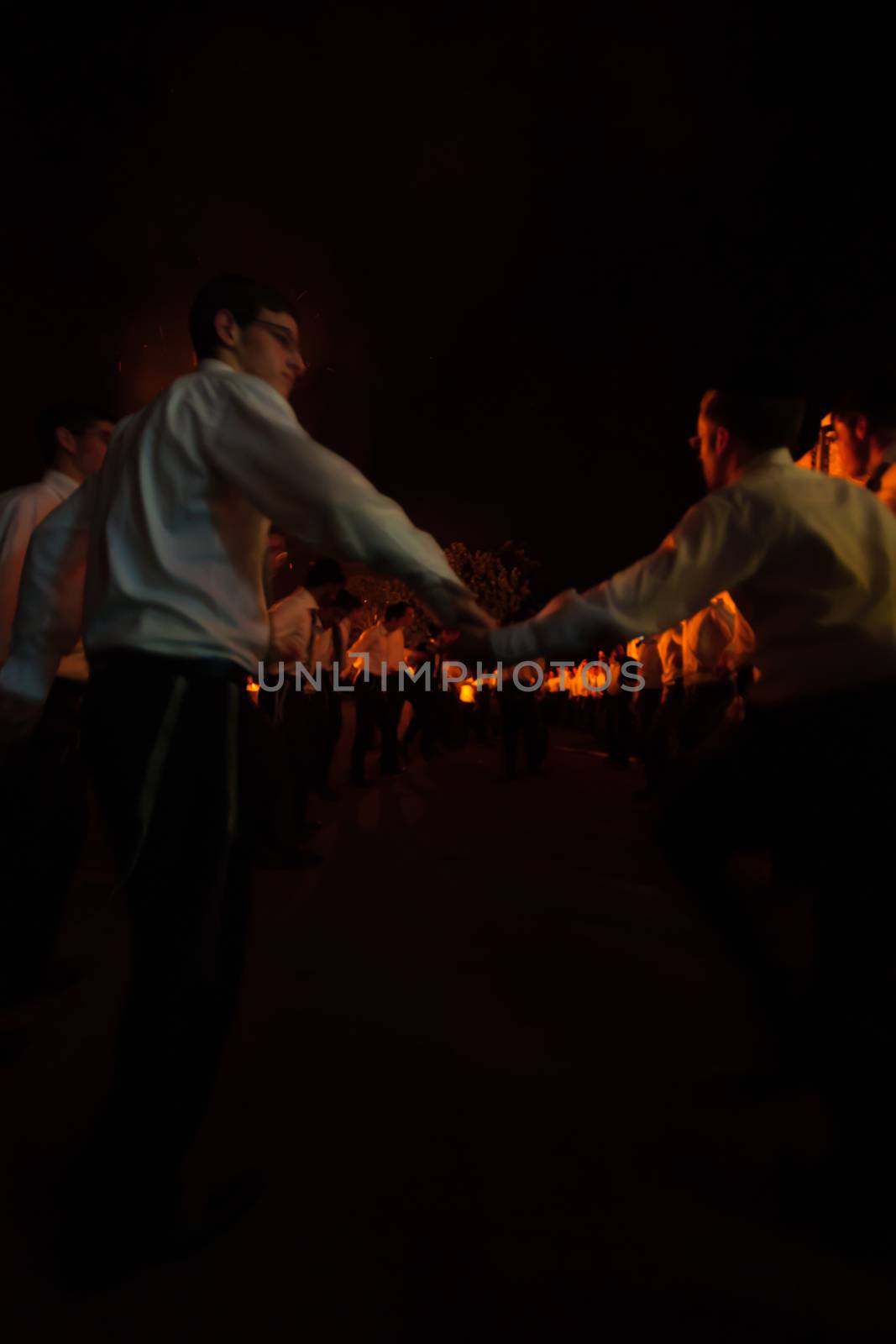 HAIFA, ISRAEL - MAY 01, 2010: Orthodox Jews dance around a bonfire to celebrate the Jewish holiday of Lad-BaOmer, in Haifa, Israel