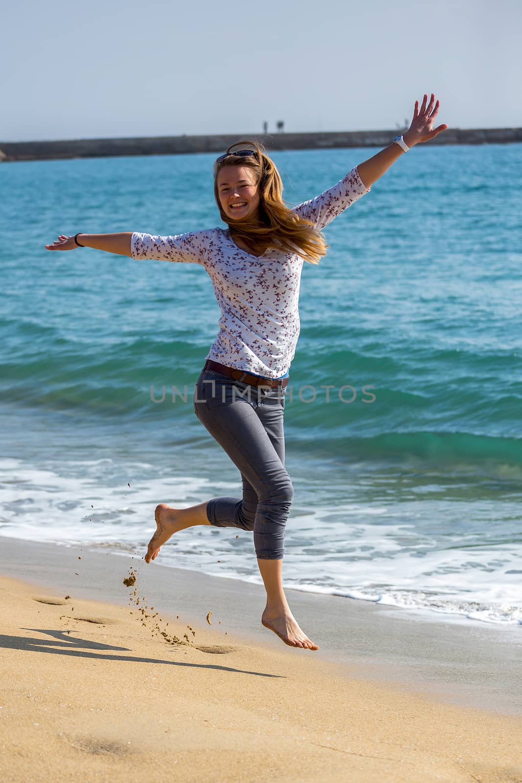Pretty girl jumping near the lake by Digoarpi