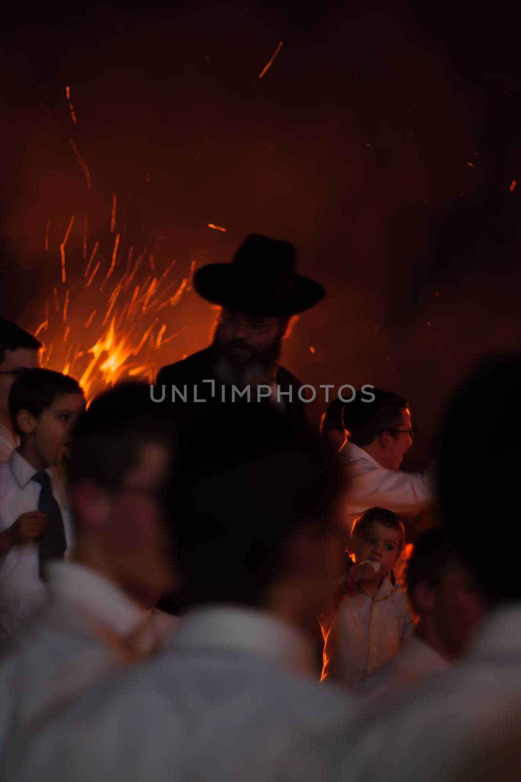 HAIFA, ISRAEL - MAY 01, 2010: Orthodox Jews dance around a bonfire to celebrate the Jewish holiday of Lad-BaOmer, in Haifa, Israel