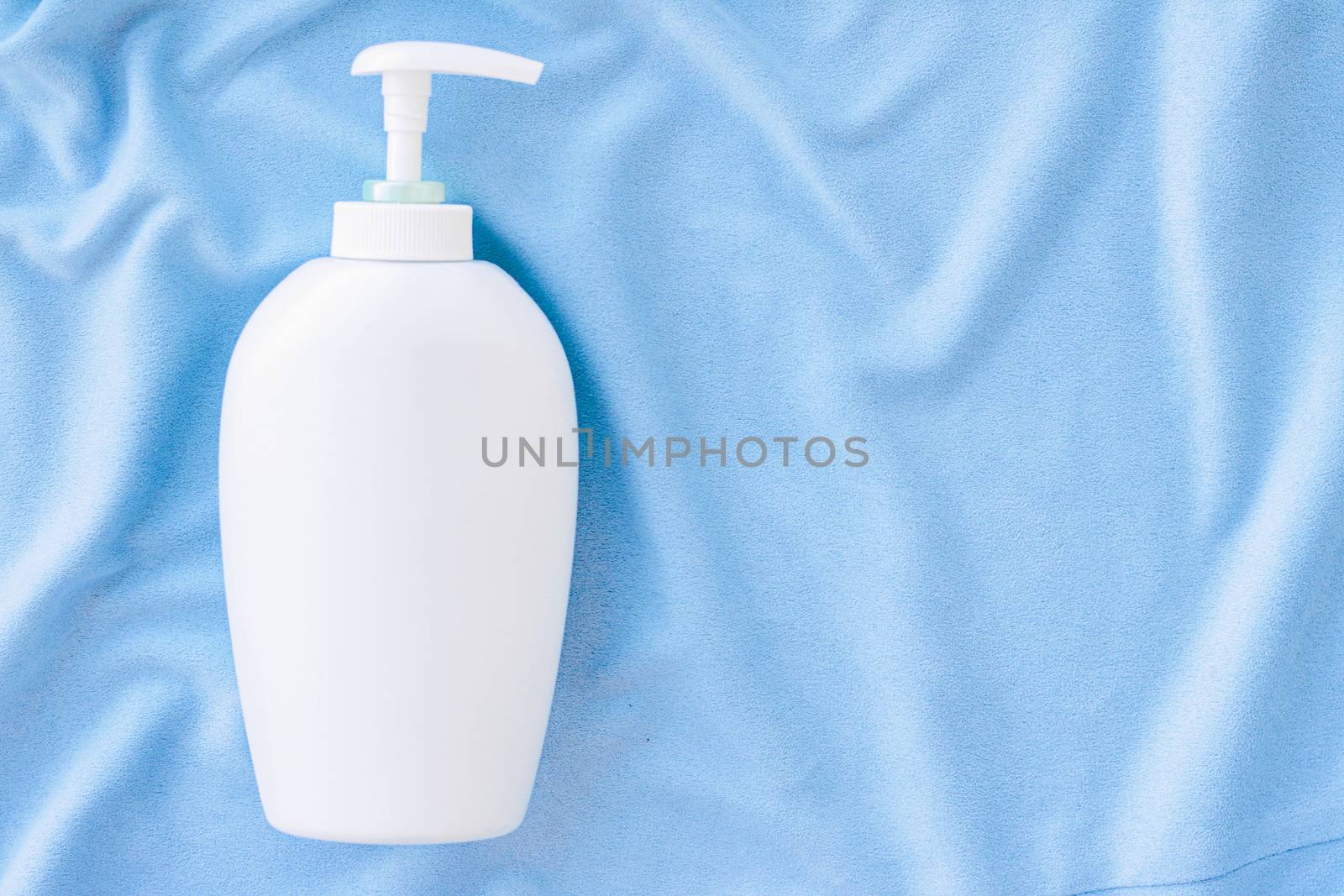 Blank label bottle of antibacterial liquid soap and hand sanitizer mockup on blue silk, hygiene product and health care, flatlay