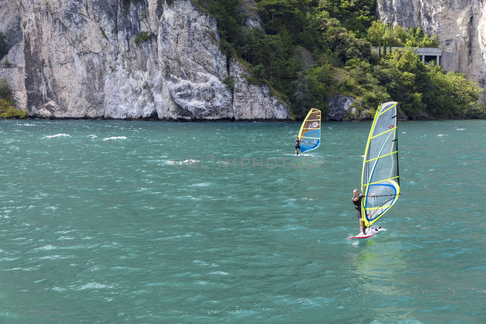 Lake Garda, Italy, August 2019, windsurfers on the lake by ElectricEggPhoto