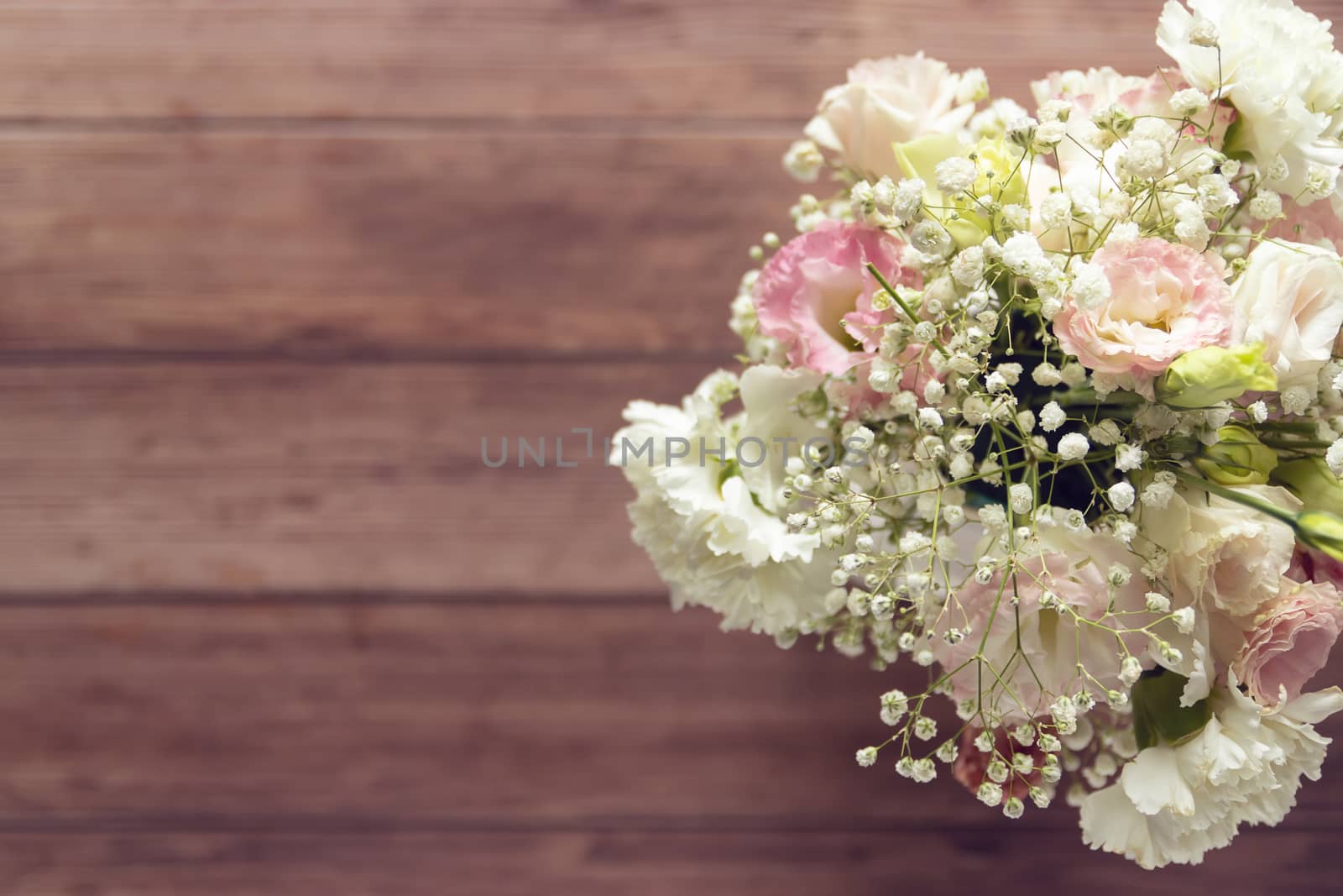 top view of beautiful romantic bouquet fresh spring flower on wooden table background with copy space