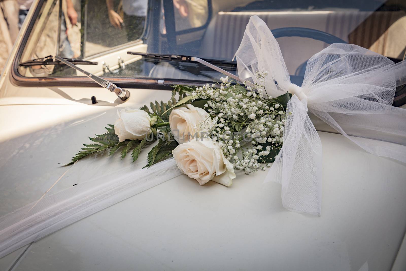 Malcesine, Lake Garda, Italy, August 2019, some wedding flowers on a Fiat 500 bonnet