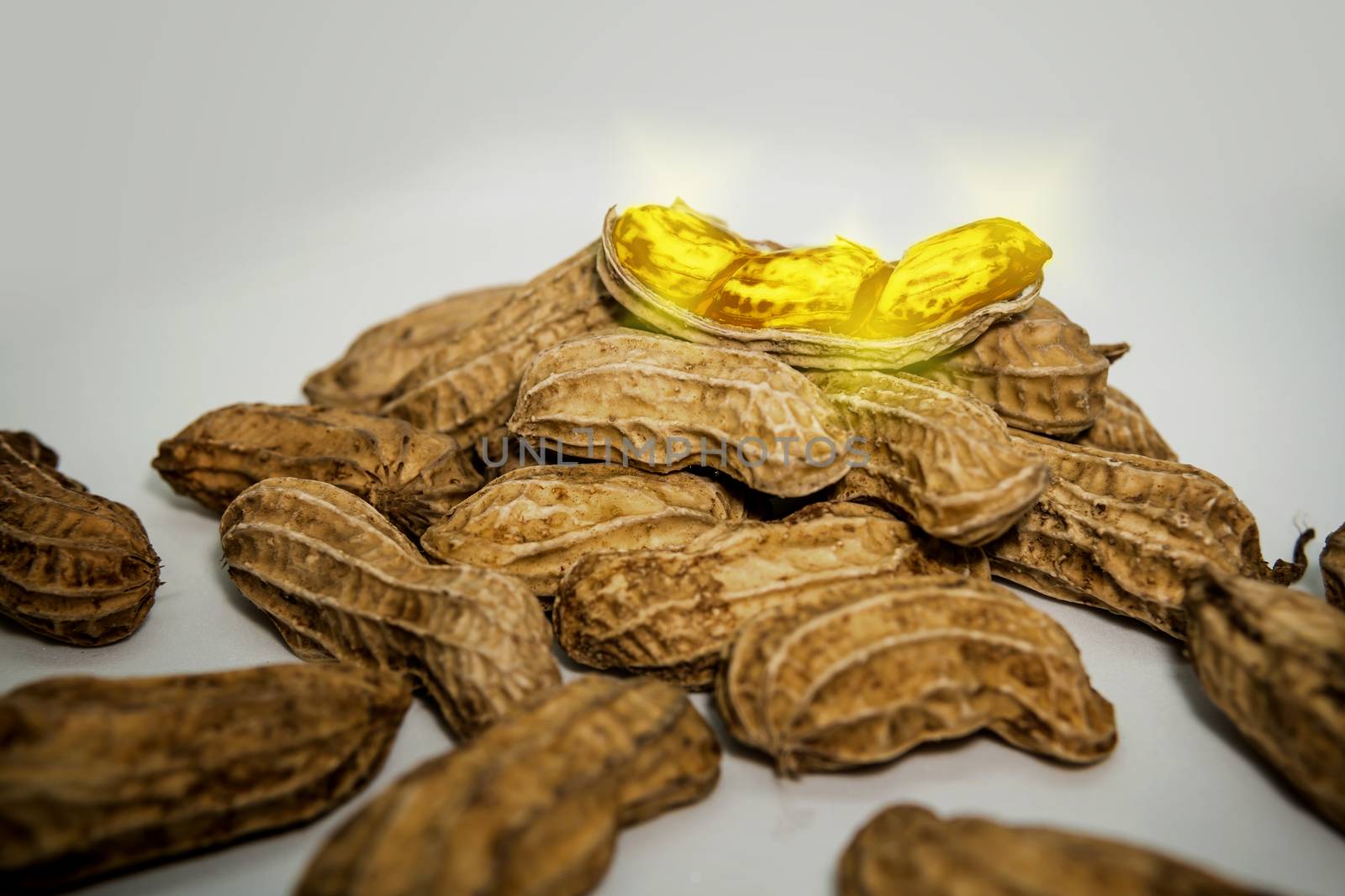 Fantasy. Mutant peanuts are golden, placed on a white background.