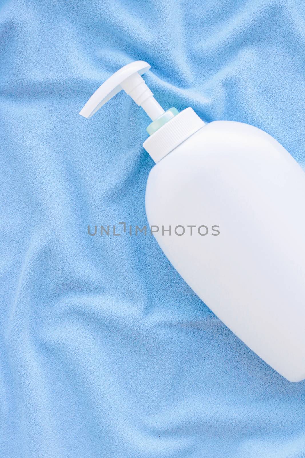 Blank label bottle of antibacterial liquid soap and hand sanitizer mockup on blue silk, hygiene product and health care, flatlay