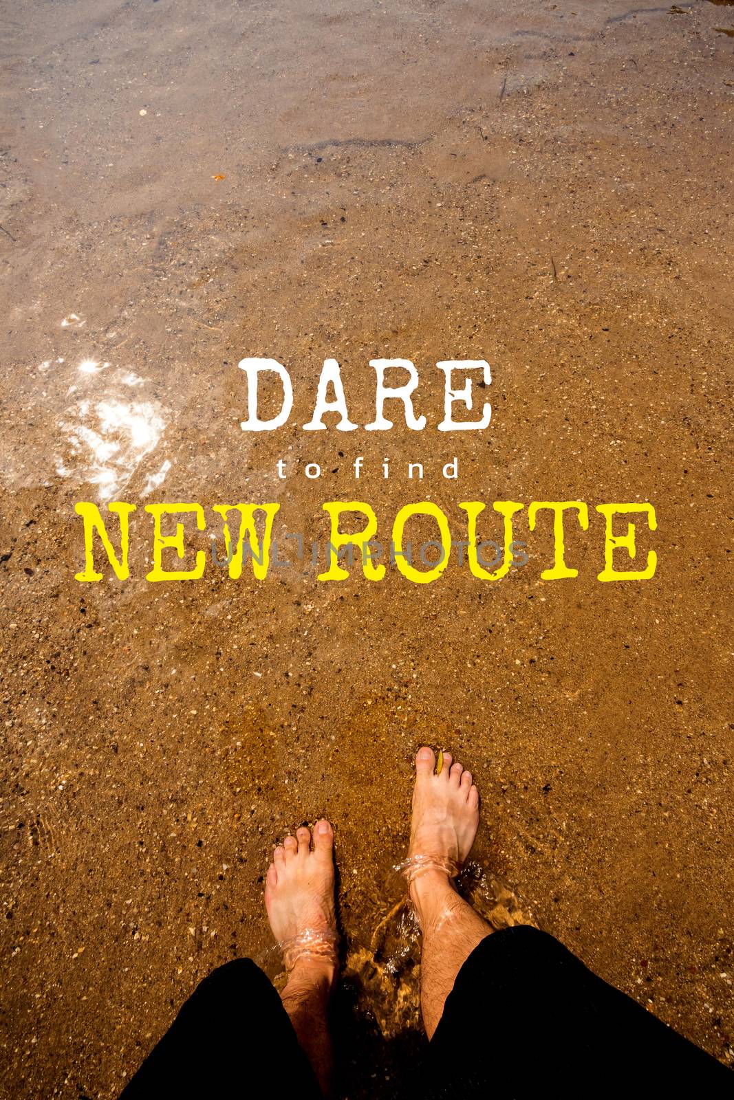 typography motivational messages and inspirational quotes. phrase DARE TO FIND NEW ROUTE. Man's feet on the sand in the river background.