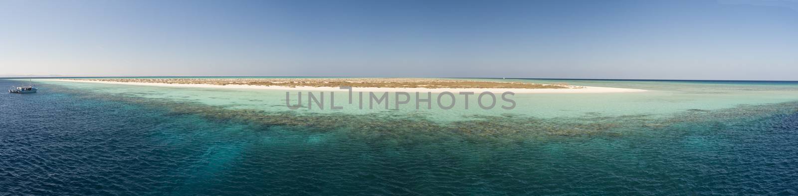 Wide panoramic image of view over a remote tropical desert island