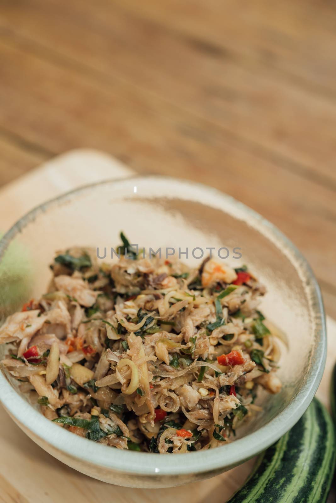 Thai southern spicy Budu salad is anchovies sauce and one of the best known fermented seafood products and herb is a Thai food have a hot and spice in Thai street food market at Bangkok Thailand