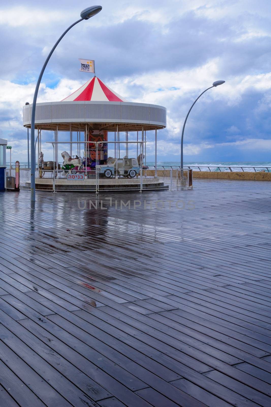 TEL-AVIV - JANUARY 25, 2016: Winter scene with a restored carrousel and a commercial area in Tel-Aviv Port, Tel-Aviv, Israel. The port compound was restored as a dining and commercial area