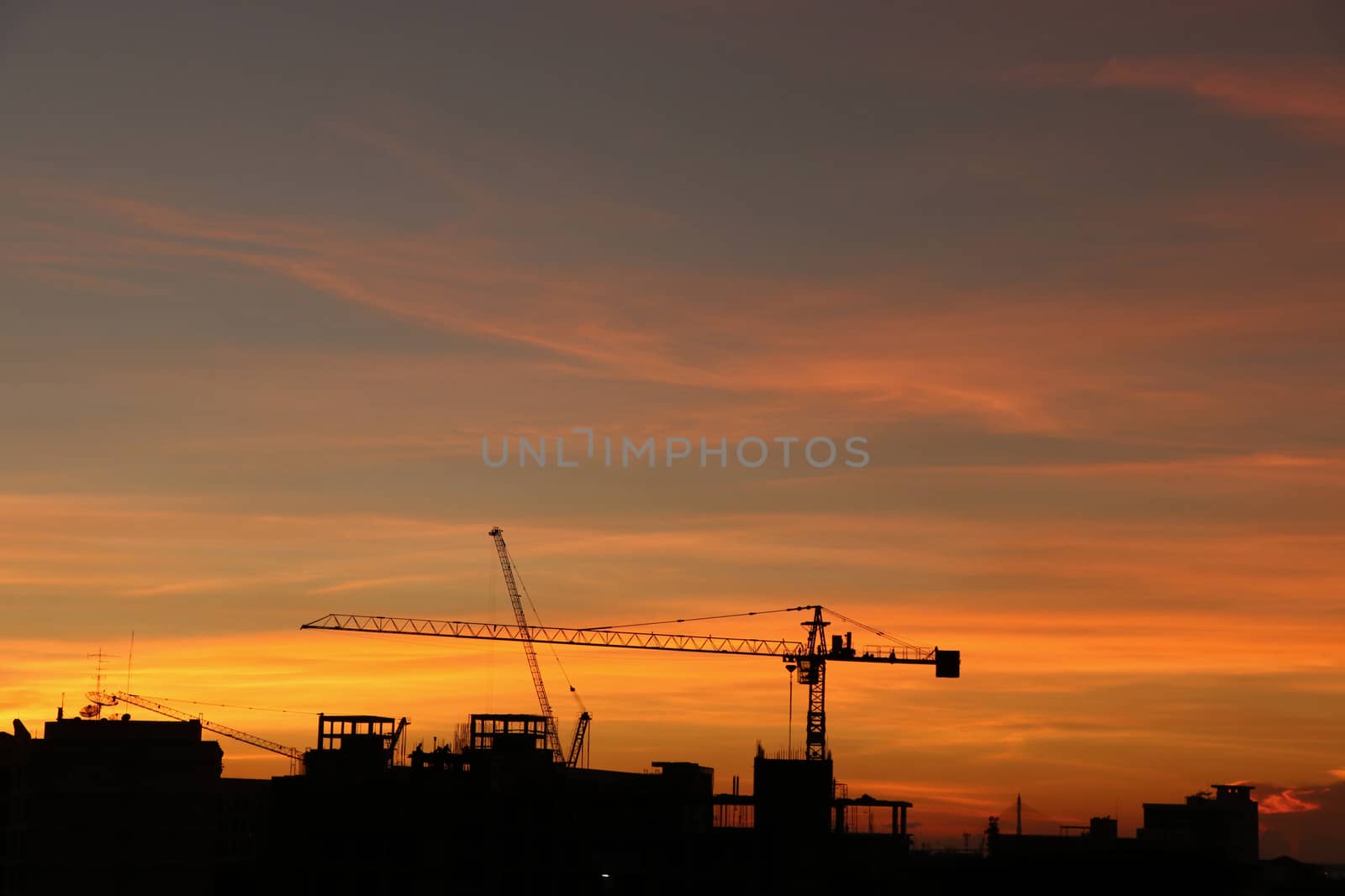 Silhouette construction  and crane sunset background  sky gold c by louisnina
