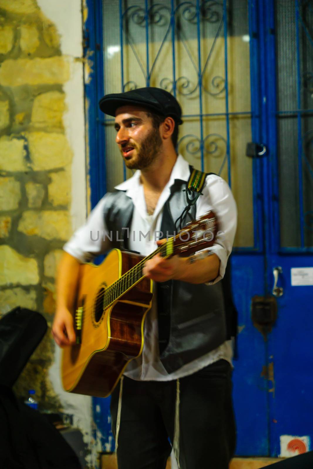 SAFED, ISRAEL - AUGUST 23, 2017: Scene of the Klezmer Festival, with street musician playing, in Safed (Tzfat), Israel. Its the 30th annual traditional Jewish festival in the public streets of Safed