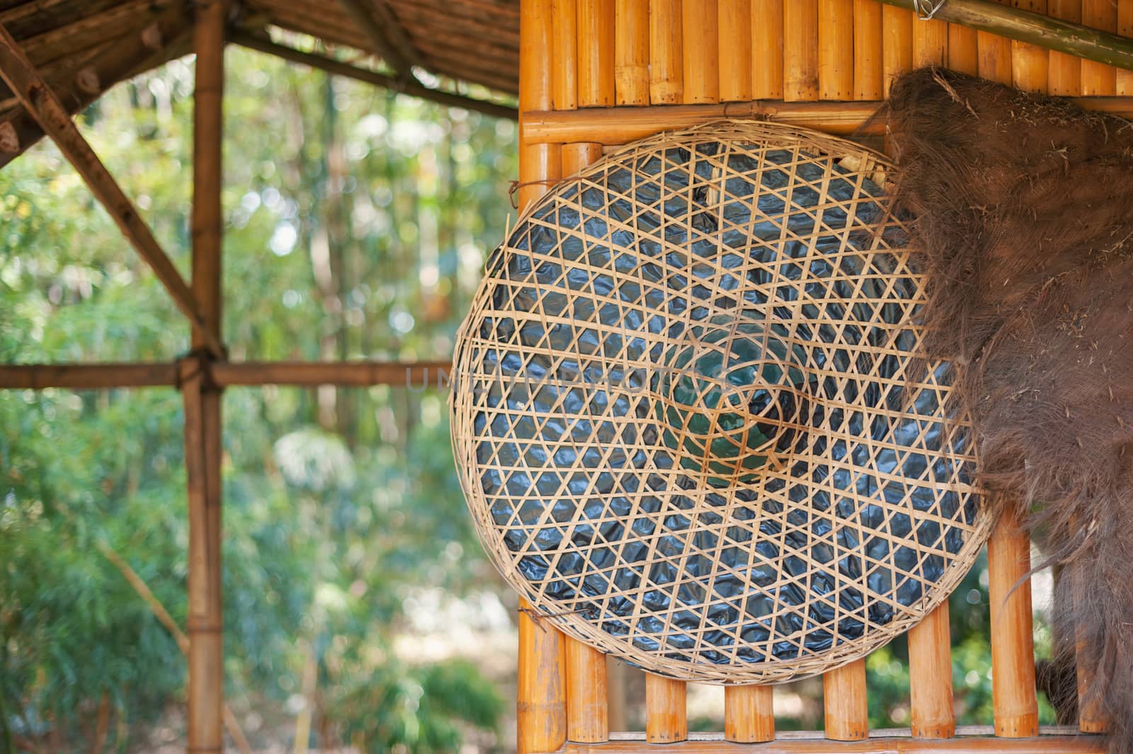 Chinese straw hat hanging on a bamboo wall in the countryside, China