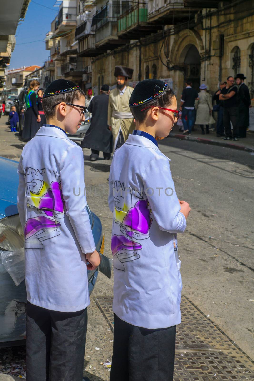 JERUSALEM, ISRAEL - MARCH 25, 2016: Street scene of the Jewish Holyday Purim, with locals, some wearing costumes, in the ultra-orthodox neighborhood Mea Shearim, Jerusalem, Israel