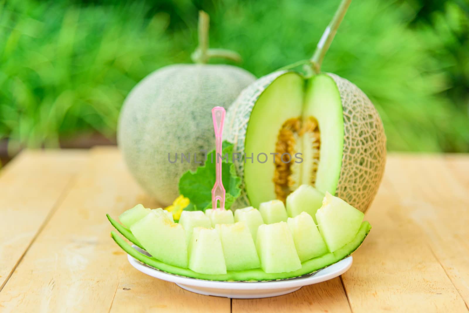 Fresh Green melon on wood plate by rukawajung
