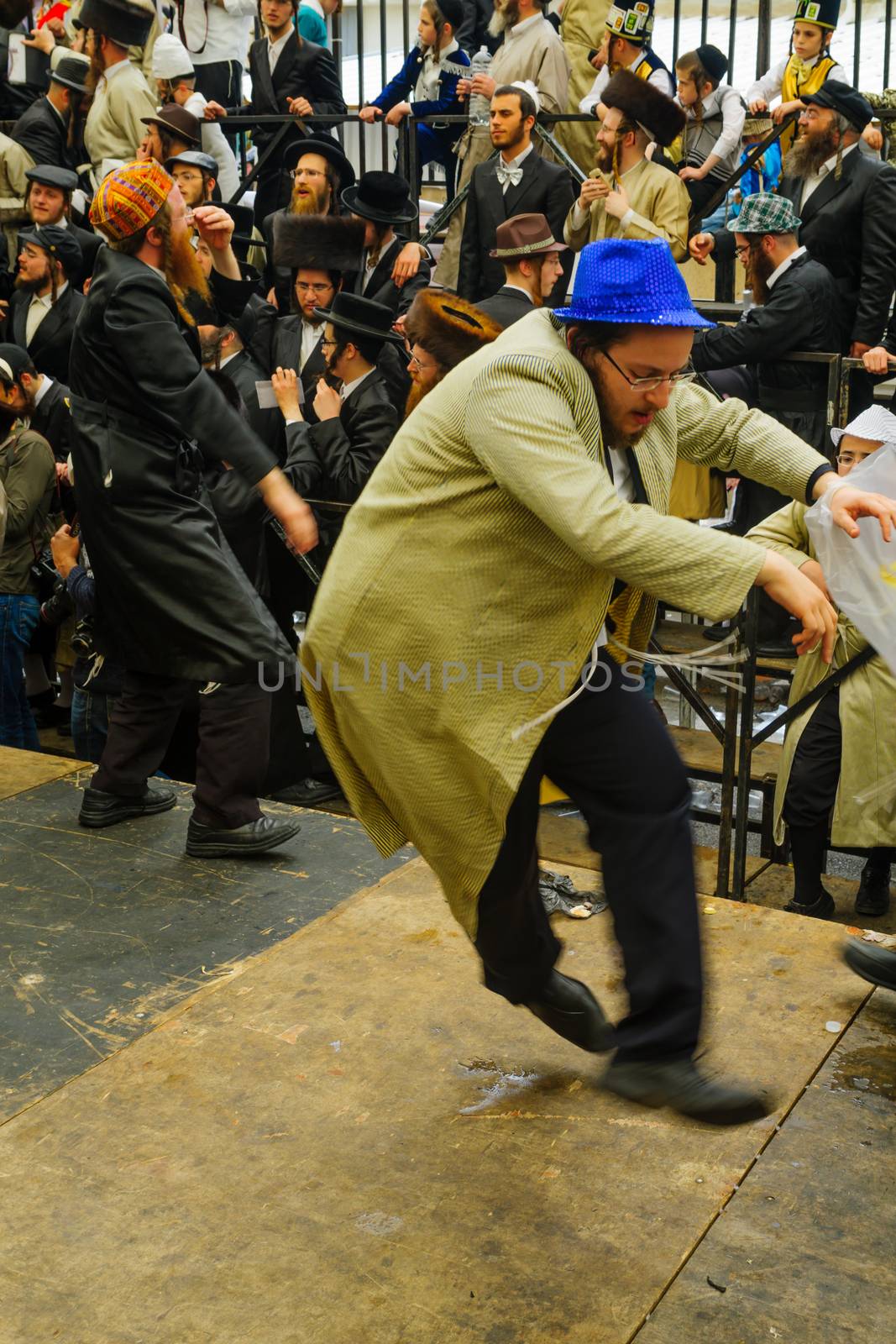 JERUSALEM, ISRAEL - MARCH 25, 2016: Jewish men attend and dance, as part of a celebration of the Jewish Holyday Purim, in the ultra-orthodox neighborhood Mea Shearim, Jerusalem, Israel