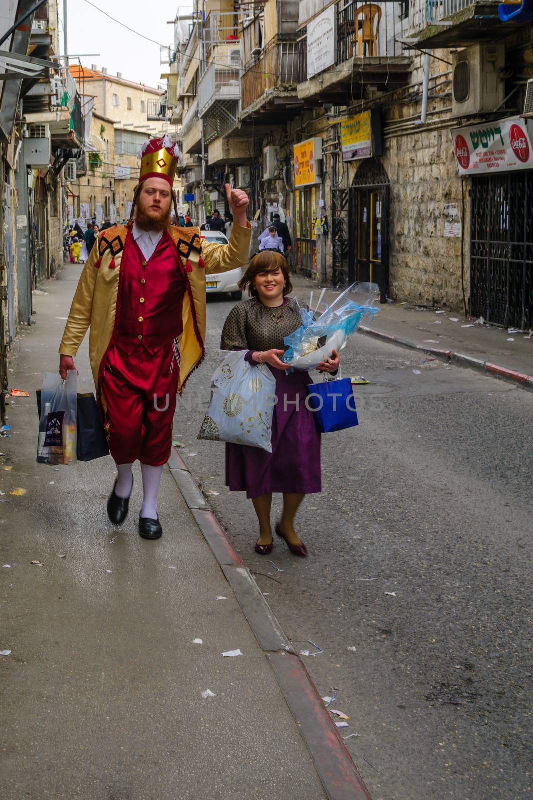 JERUSALEM, ISR - MARCH 25, 2016: Street scene of people carrying mishloach manot (portions to the poor), a Jewish Holyday Purim tradition, the ultra-orthodox neighborhood Mea Shearim, Jerusalem, Israel