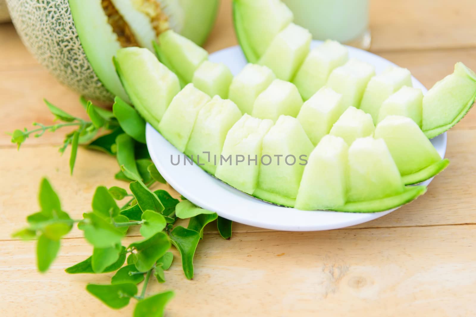 Fresh Green melon on wood plate