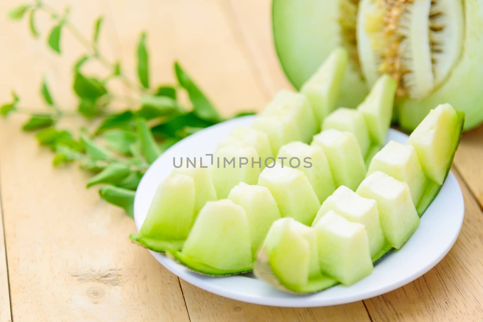 Fresh Green melon on wood plate