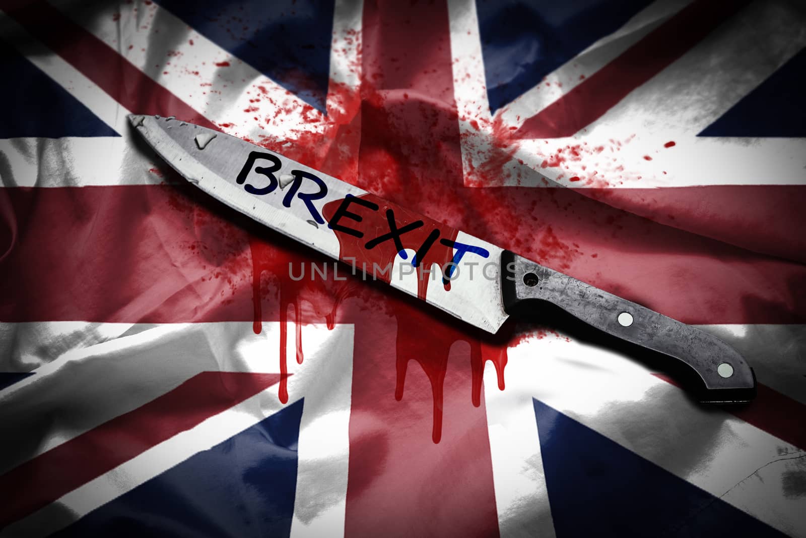 A long knife with the word Brexit stained with blood, placed on United Kingdom flag with blood spilled, Brexit concept by asiandelight