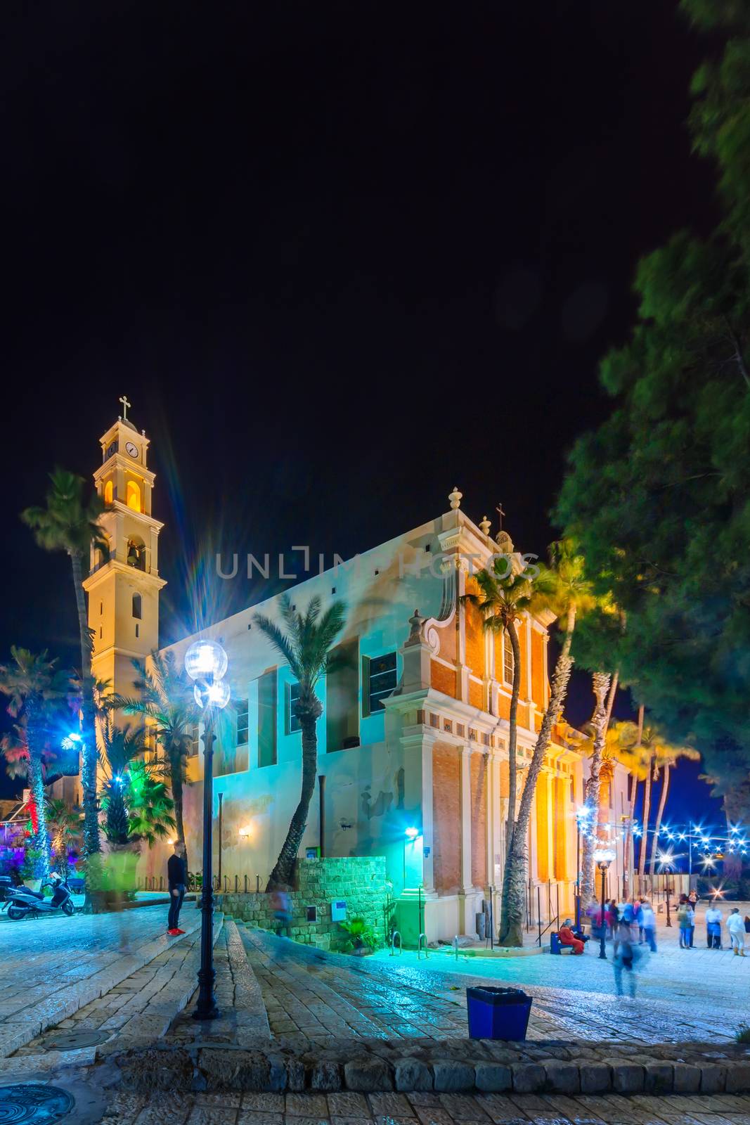 TEL-AVIV, ISRAEL - FEBRUARY 26, 2016: Night view of Kedumim square and the St. Peter Church, with locals and visitors, in the old city of Jaffa, Now part of Tel-Aviv Yafo, Israel