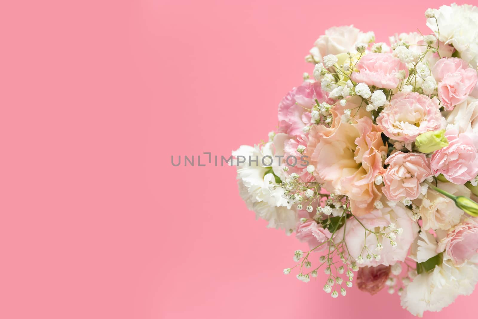 top view of beautiful romantic bouquet fresh spring flower on pink background with copy space by asiandelight