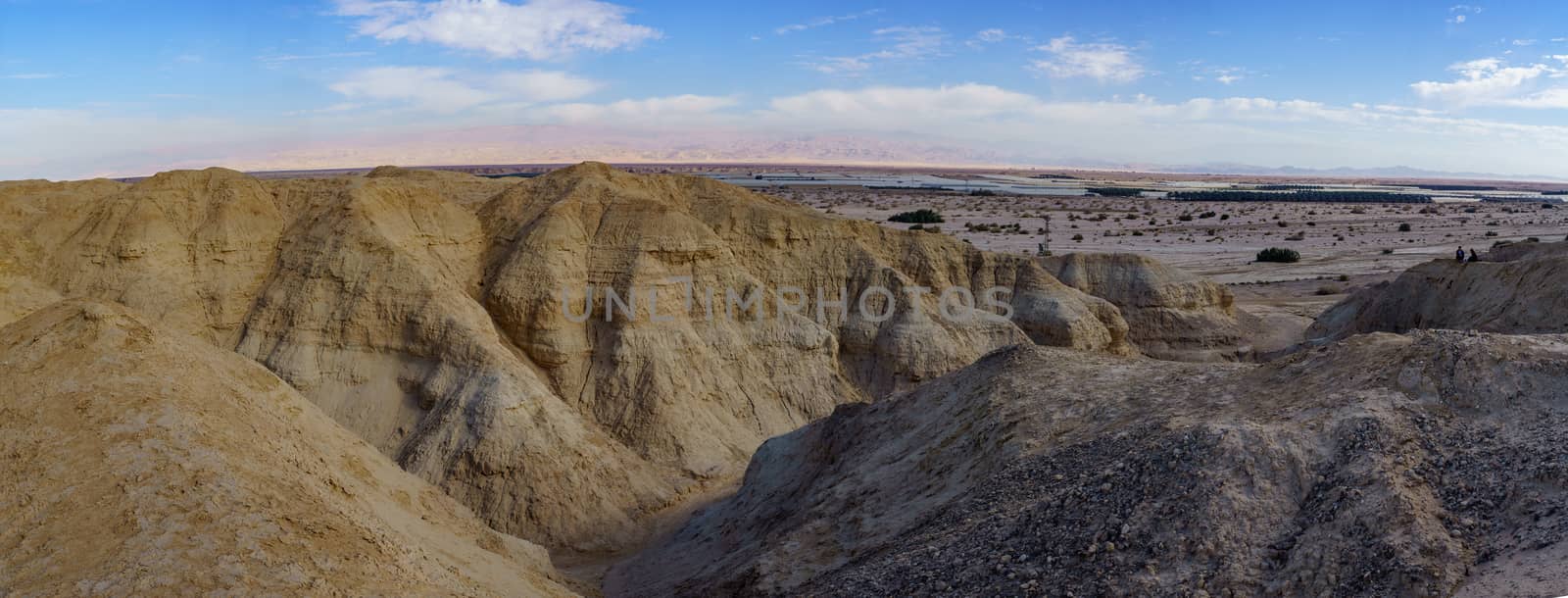 Hazeva, Israel - January 19, 2019: Panoramic Landscape of lissan marl rocks, the Edom mountains, and visitors hiking, along the Arava Peace Road, Southern Israel