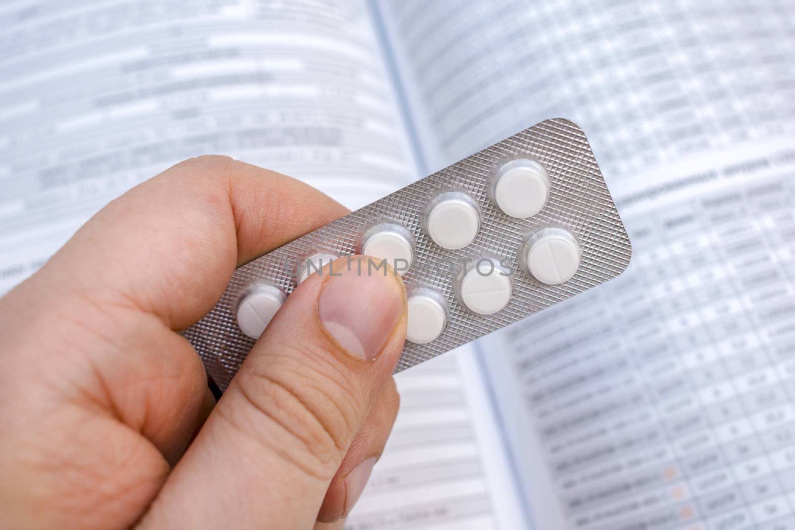 Packing tablets in the hands of a patient or doctor. Medications for treating patients in a pharmacy