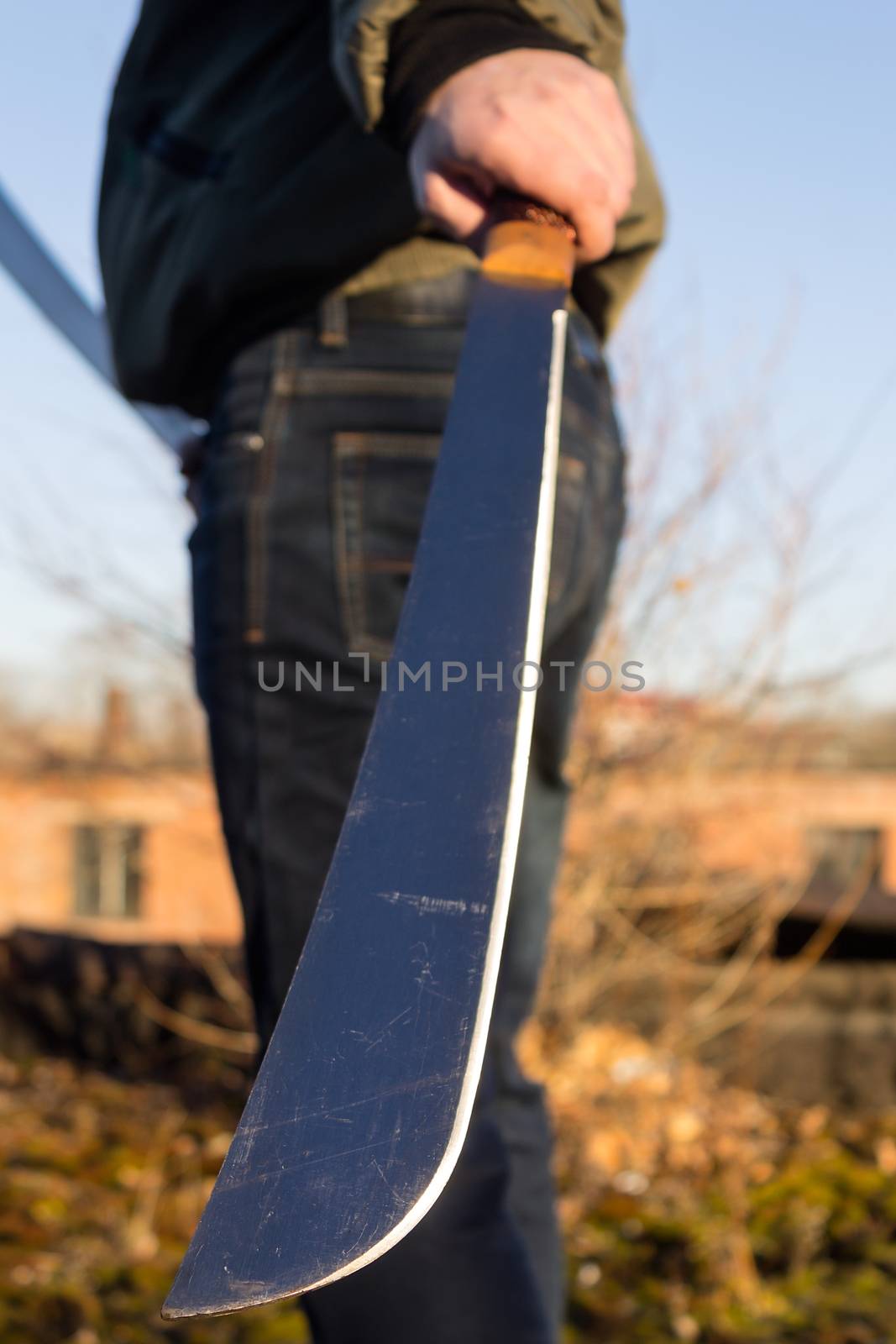 Sharp machete blade close-up in hands