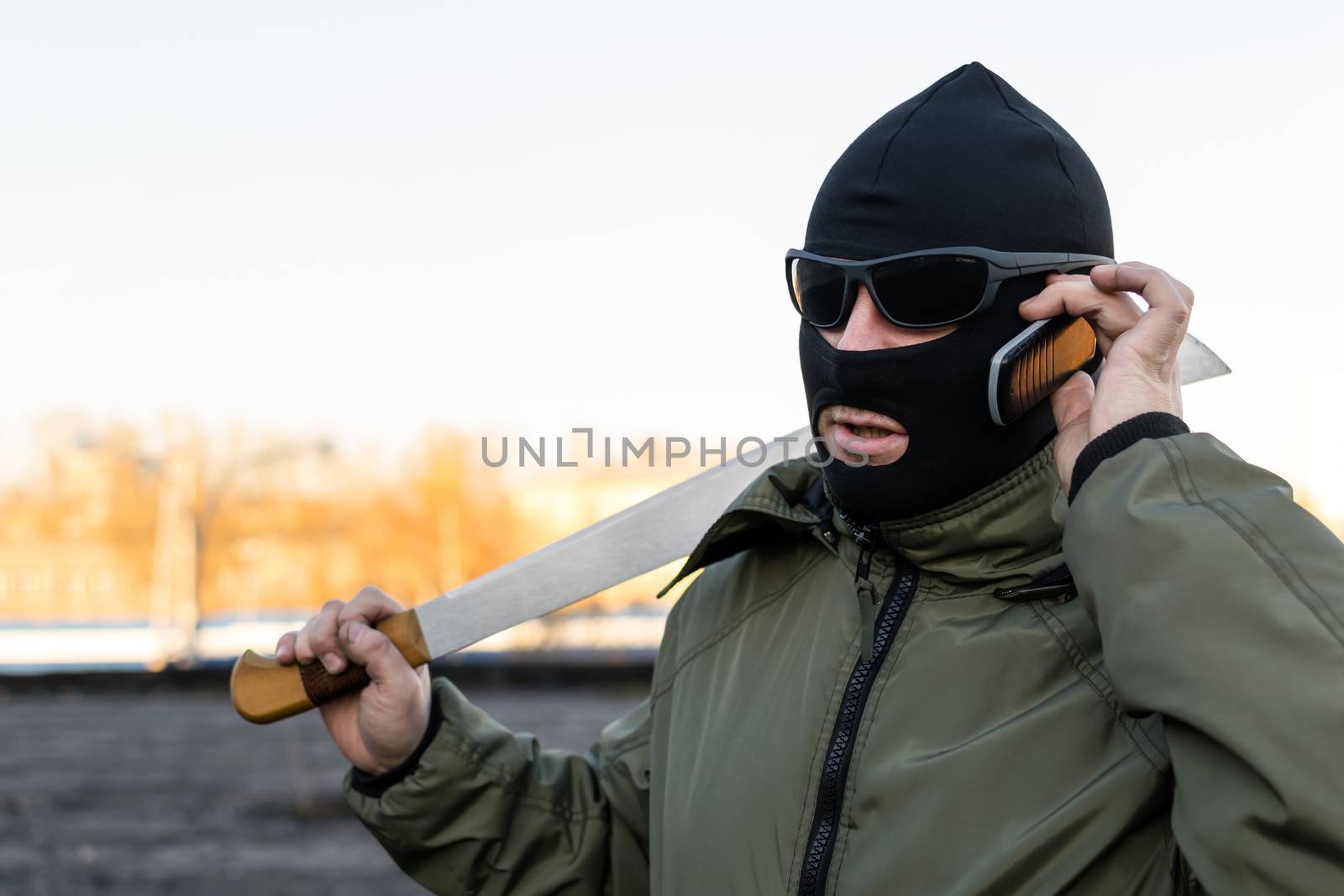 The bandit in glasses and a mask on the phone