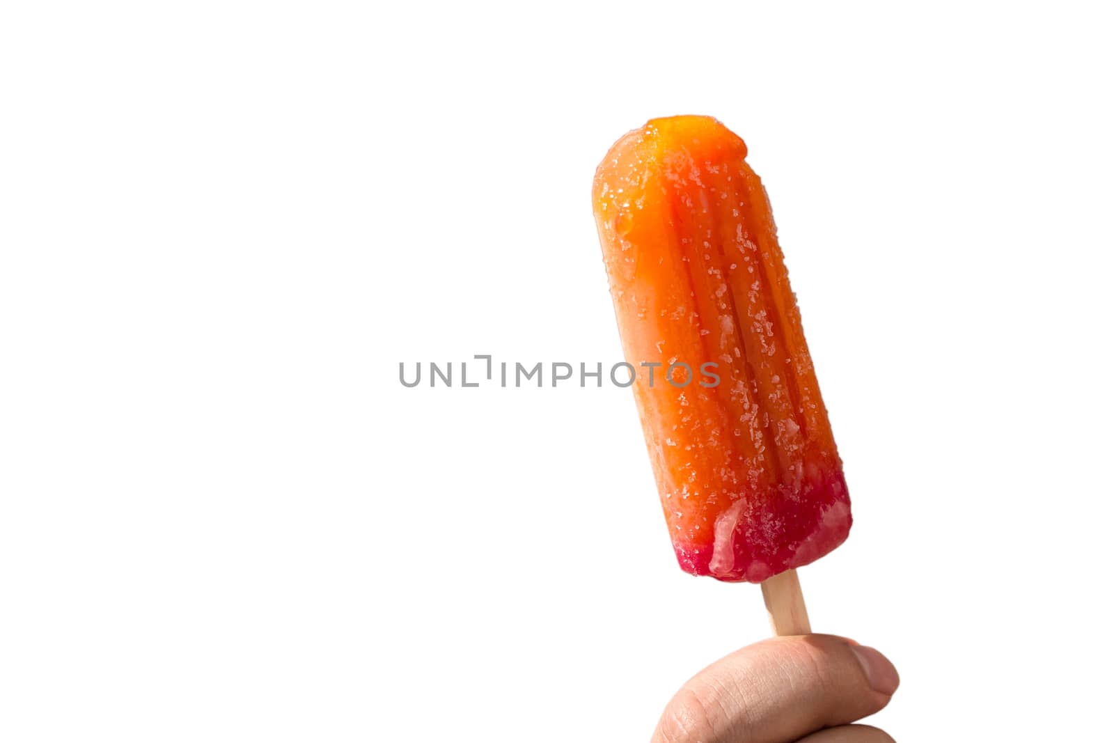 Juicy popsicles on a stick in a hand on a white background