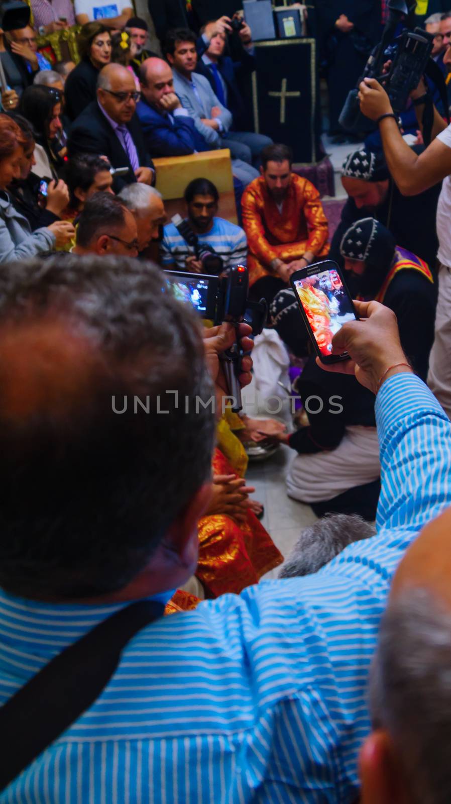 JERUSALEM, ISRAEL - APR 28, 2016: Washing of the Feet ceremony, in the Syrian Orthodox St. Marks church, with the patriarch and community members. Orthodox Holy Thursday in the old city of Jerusalem, Israel