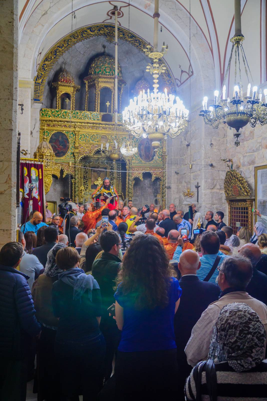 JERUSALEM, ISRAEL - APR 28, 2016: Washing of the Feet ceremony, in the Syrian Orthodox St. Marks church, with the patriarch and community members. Orthodox Holy Thursday in the old city of Jerusalem, Israel