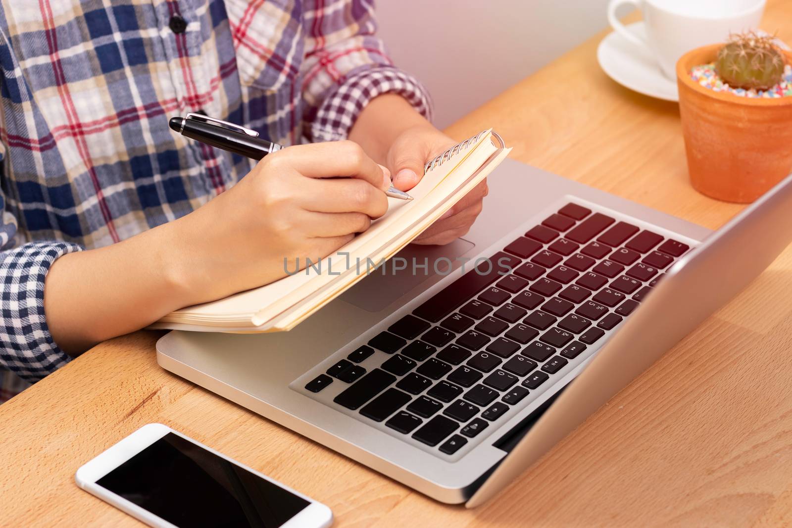 online learning course concept. student using computer laptop for training online course and writing lecture note in notebook. distance education