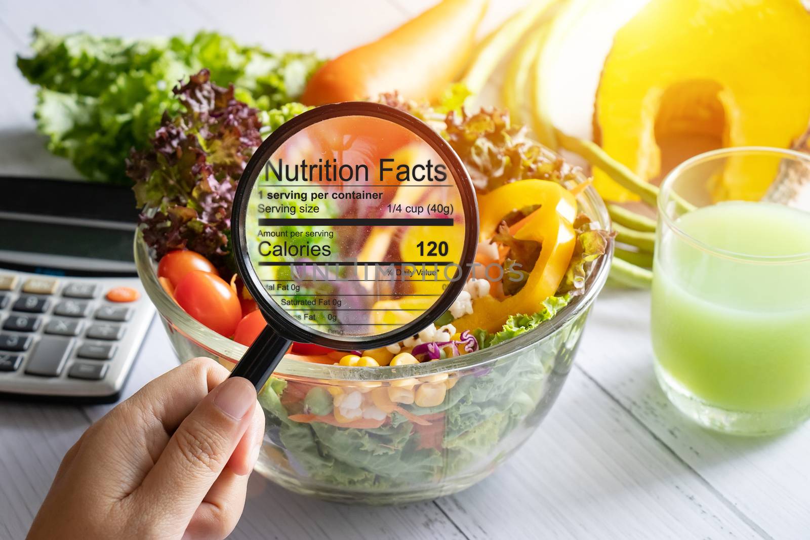 nutritional information concept. hand use the magnifying glass t by asiandelight