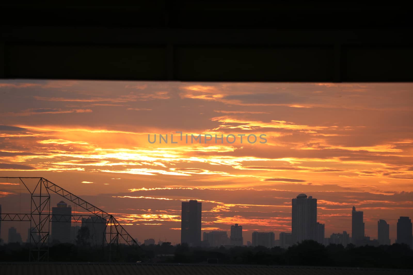 Cityscape sunset view looking from window the sky with clouds golden color romance time