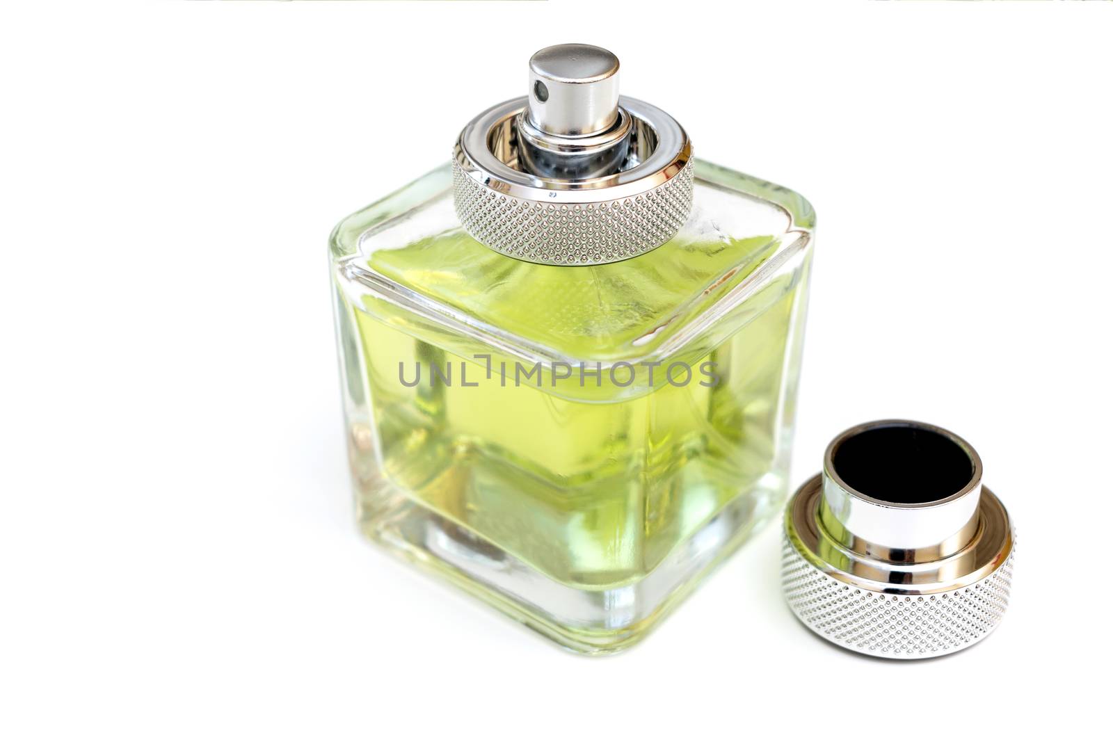 Bottle of fragrant perfume in green on a white background with an open lid