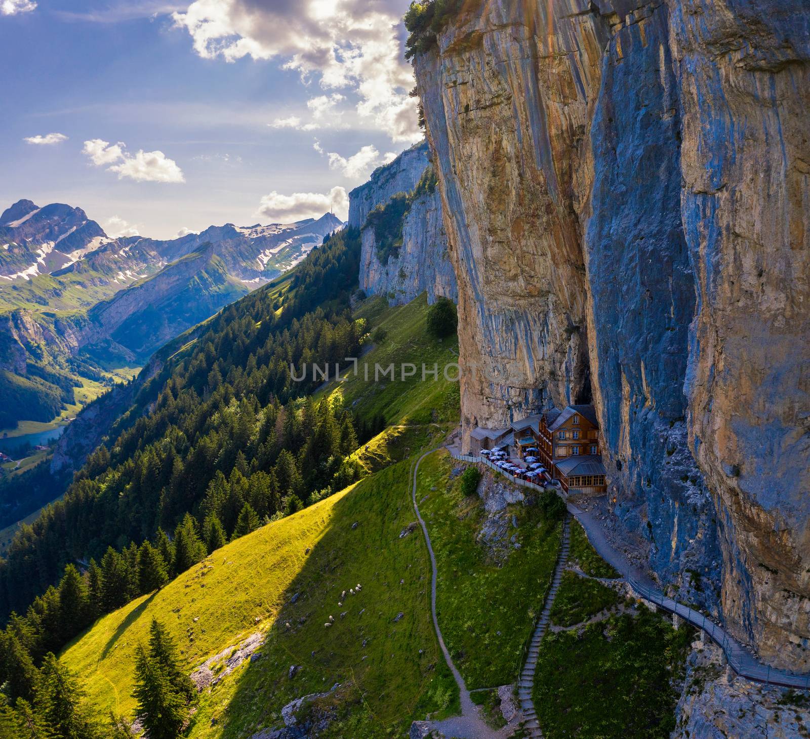 Swiss Alps and a restaurant under a cliff on mountain Ebenalp in Switzerland by nickfox