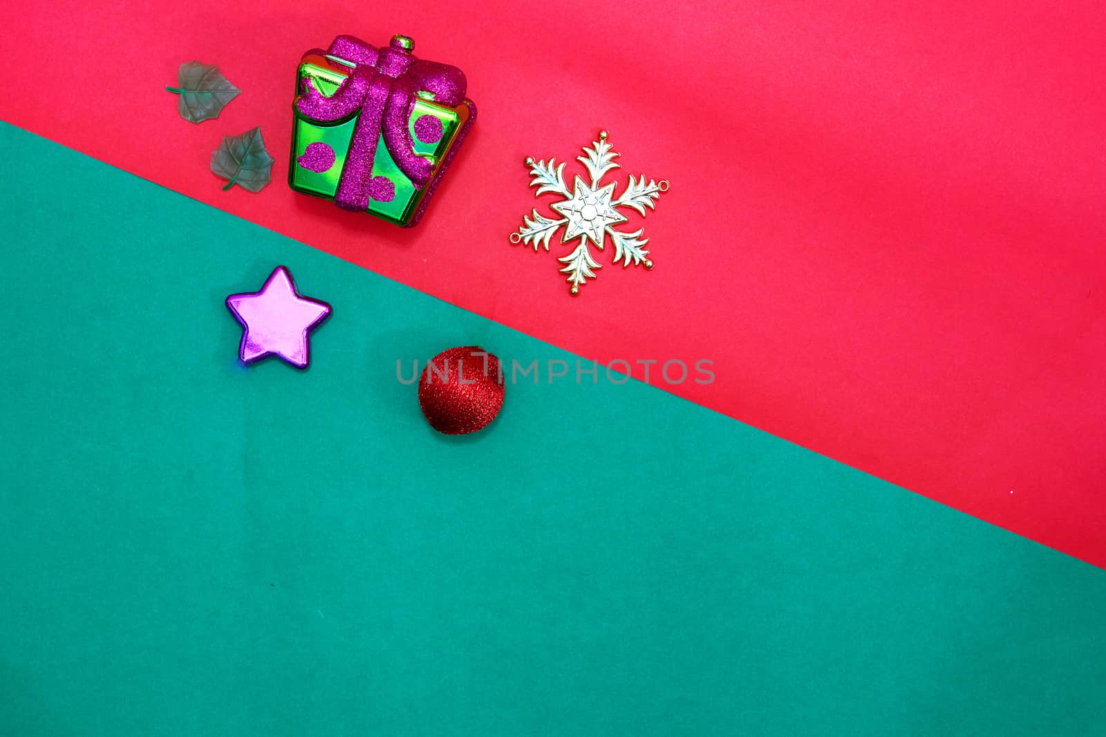Christmas present,stra,baubles,snow flake and leaves on Red green background,top  view with copy space