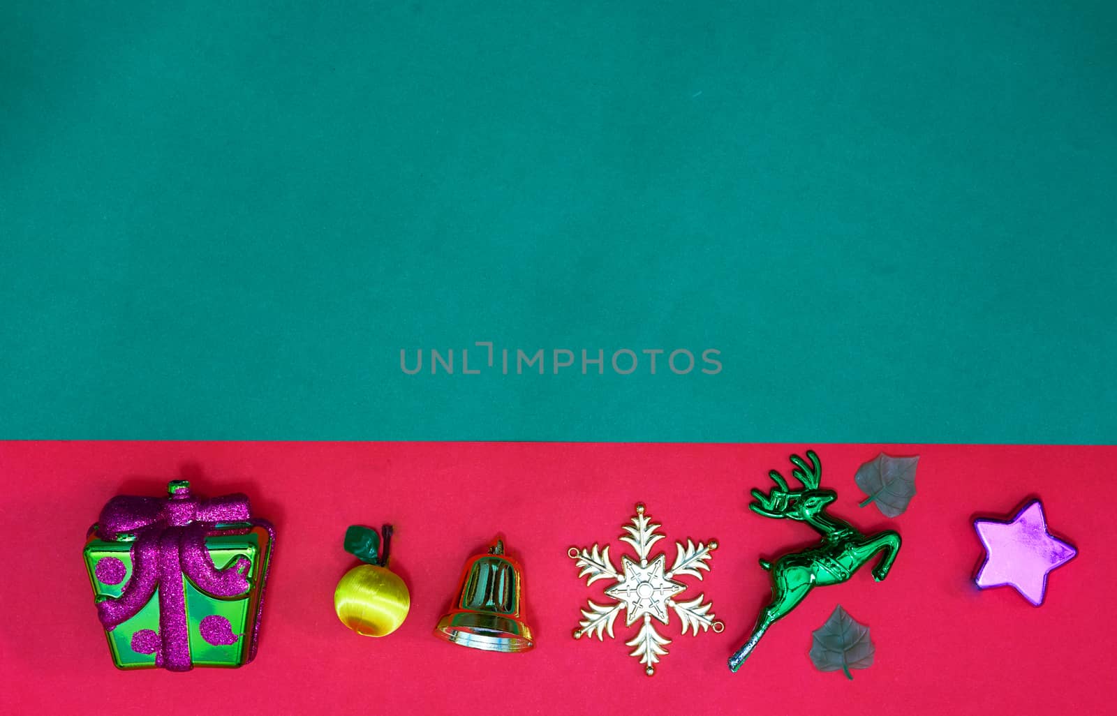 Christmas present,reindeer snowflake fruits and bell on Red green background and copy space,top  view