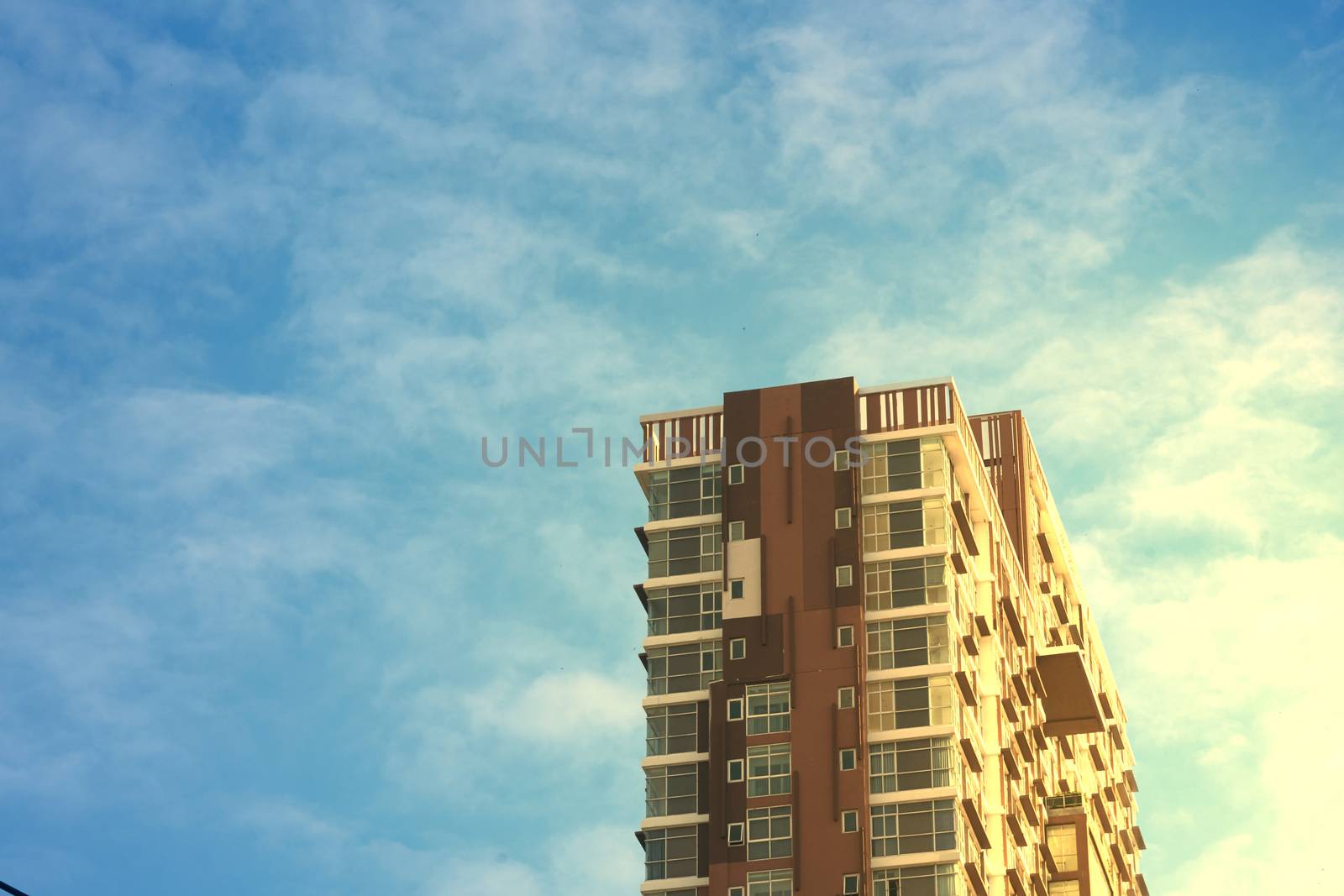 condo with sun rise light on side aspect on blue sky background in morning glory in asset concept