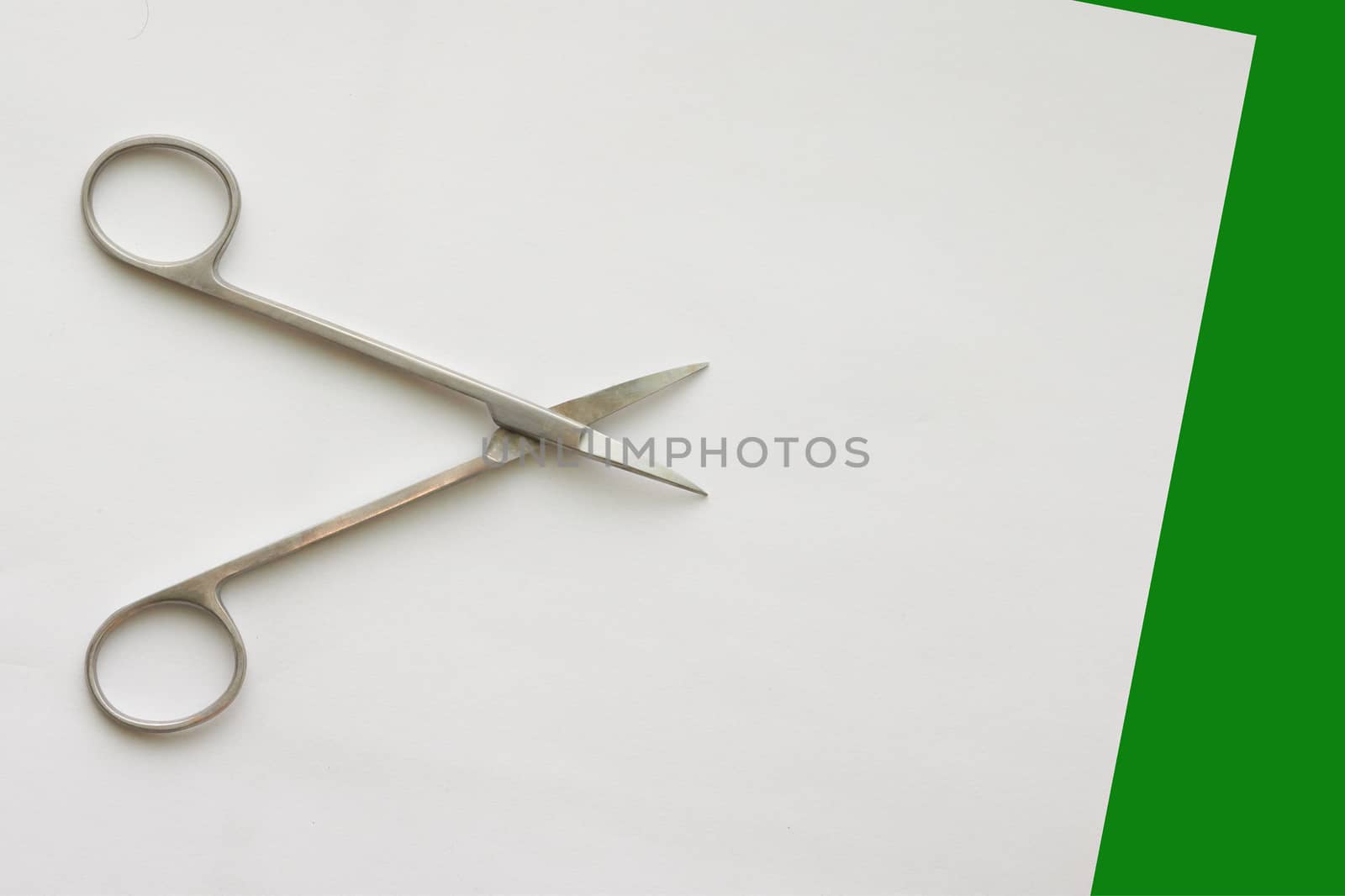 doctor scissors  on white green background with copy space