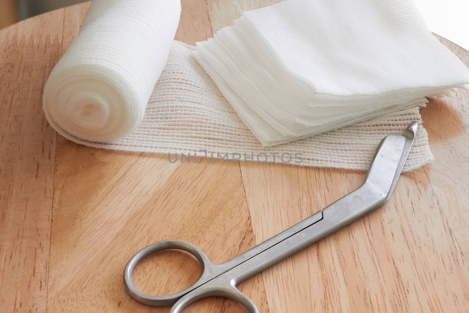 Dressing or clean wound tools includes Roll gauze,pile of gauzes and gauze roll cutter or scissors with sun flare