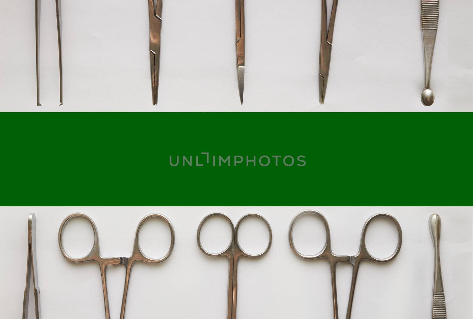 Doctor tools ,curettage ,cramps,forceps and scissors on isolated white background with green copy space